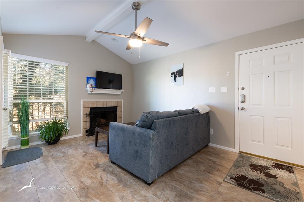 1318 Westheimer Road, Unit 217 Abilene, TX 79601 - Photo 4 of 16 a living room with furniture and a fireplace