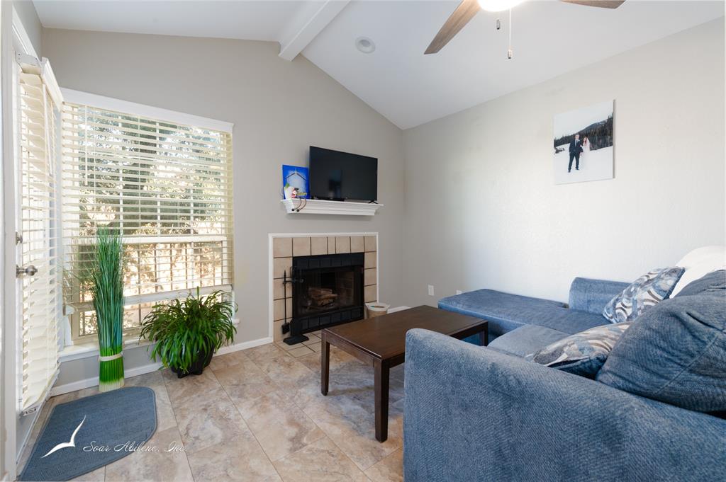 1318 Westheimer Road, Unit 217 Abilene, TX 79601 - Photo 6 of 16 a living room with furniture and a fireplace