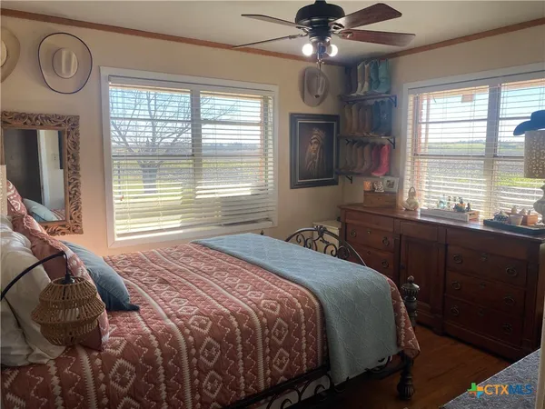 a bedroom with a large bed and a window