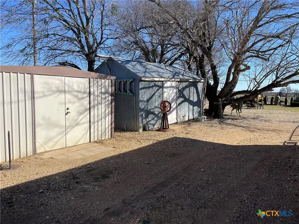 a view of backyard with large trees