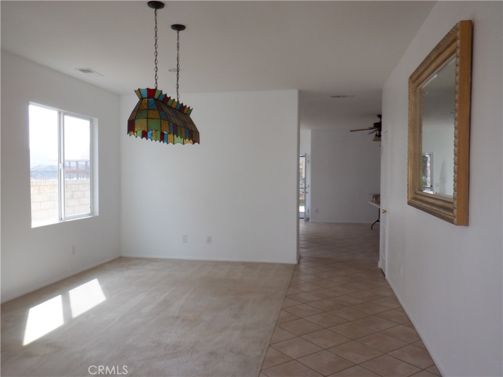 a view of a room with a window and a chandelier