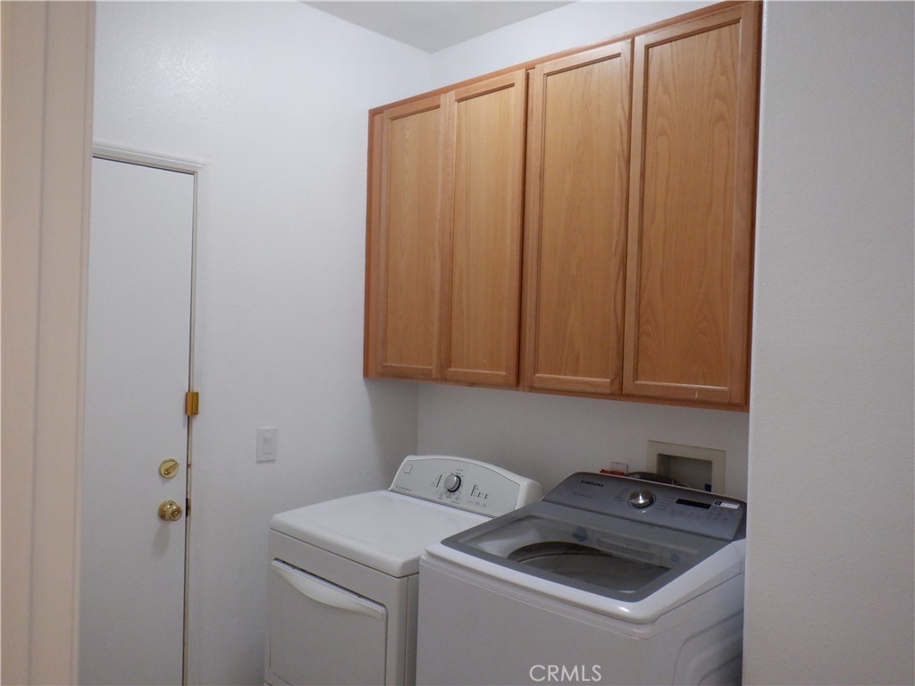 28348 Milbrook Place Castaic, CA 91384 - Photo 6 of 17 a view of storage and utility room with washer and dryer