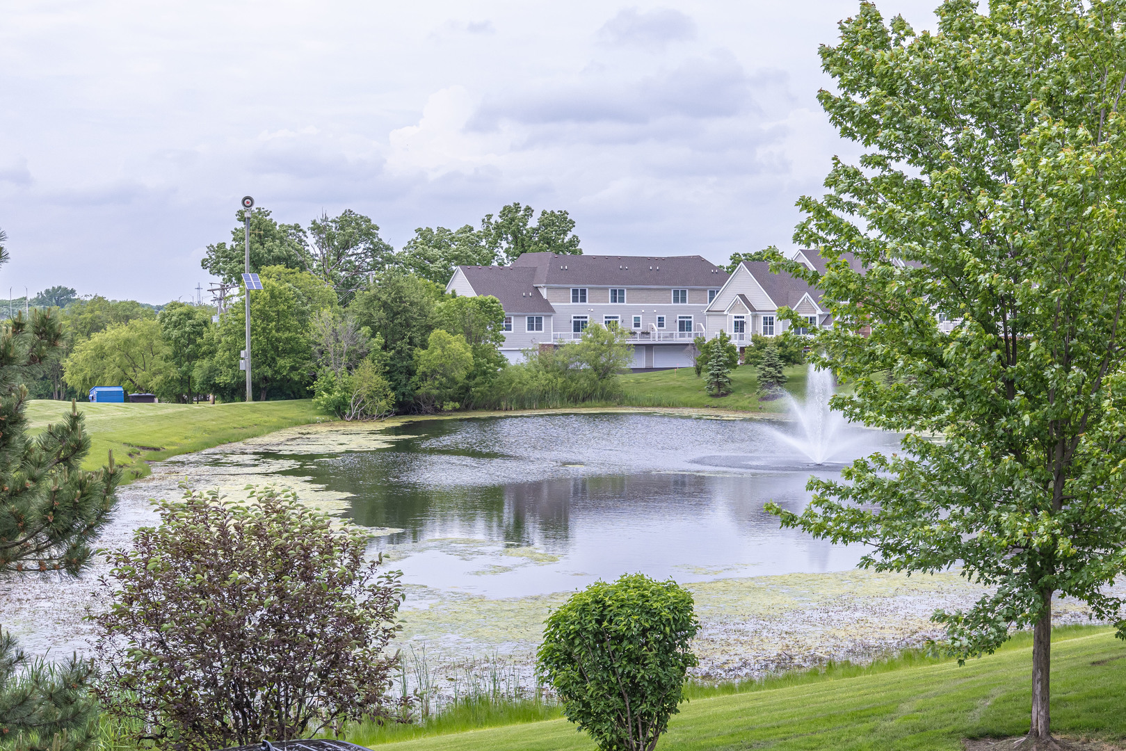 4355 Timber Ridge Court Joliet, IL 60431 - Photo 22 of 24 a view of a lake with a building in the background