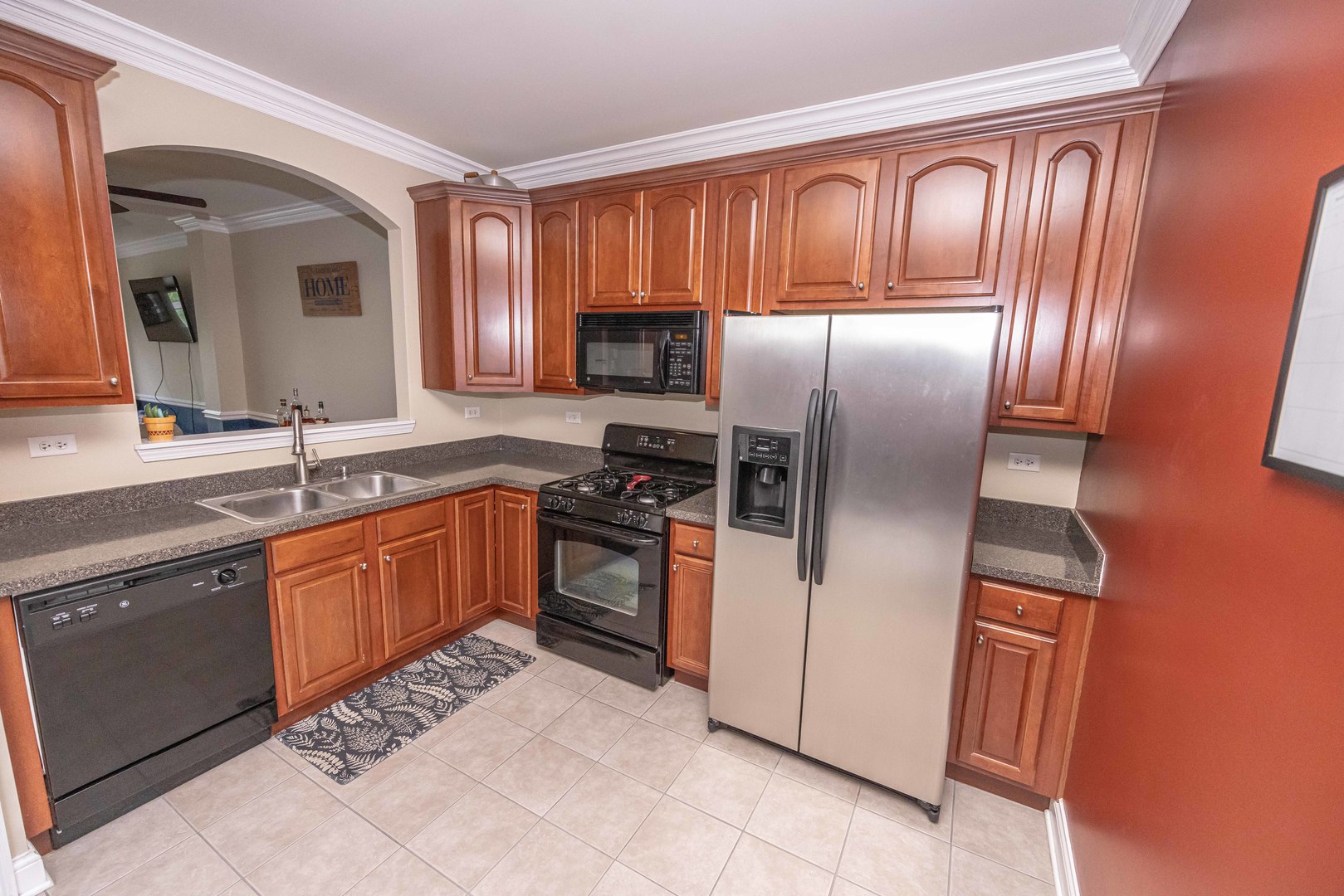 4355 Timber Ridge Court Joliet, IL 60431 - Photo 7 of 24 a kitchen with stainless steel appliances granite countertop a refrigerator and wooden cabinets