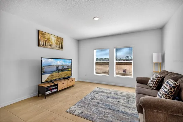 a living room with furniture gym equipment and a window