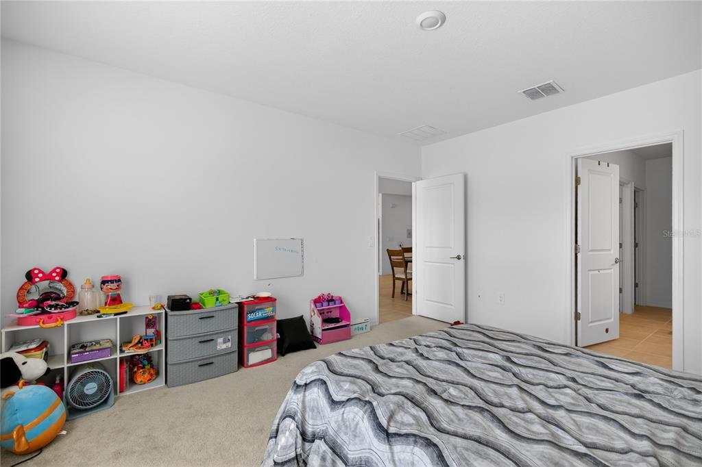 9633 Rampart Road Leesburg, FL 34788 - Photo 14 of 34 a bedroom with a bed and a closet