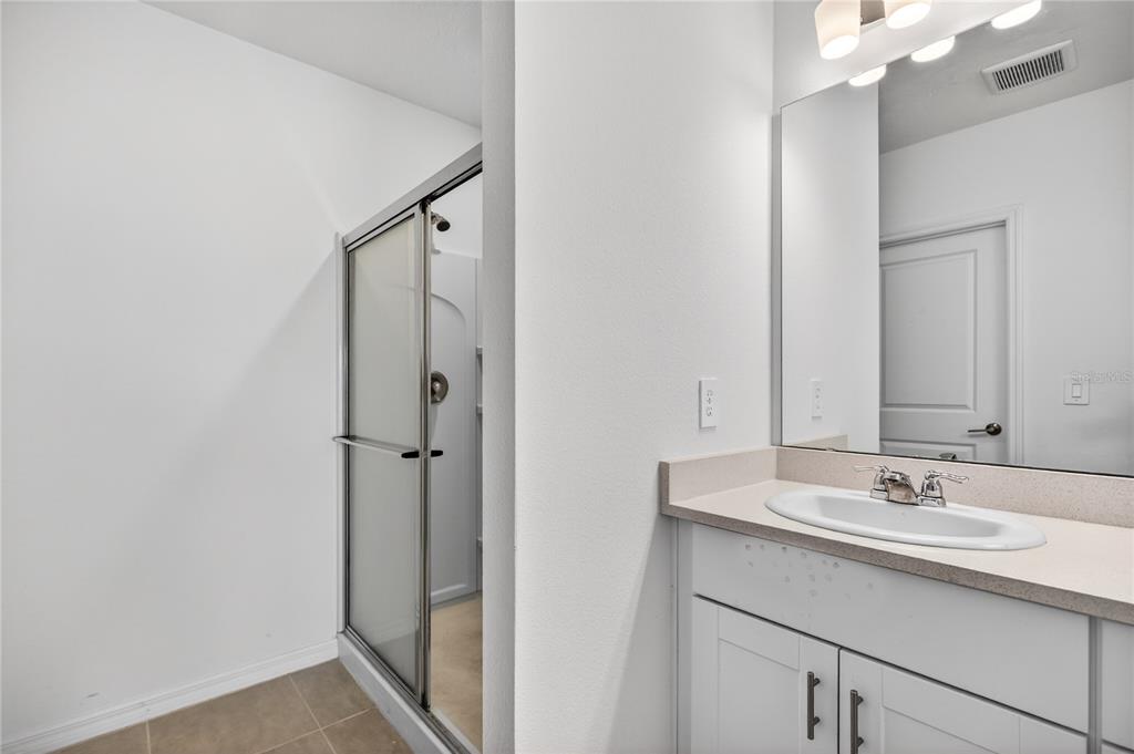 9633 Rampart Road Leesburg, FL 34788 - Photo 16 of 34 a bathroom with a sink and mirror