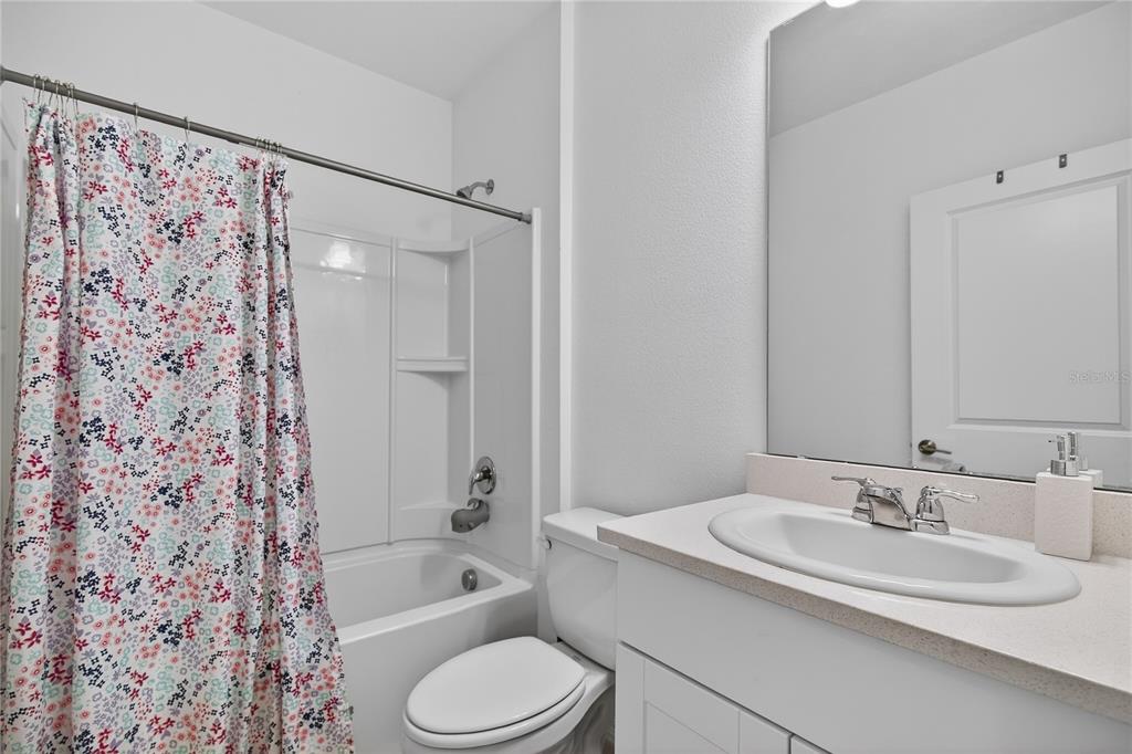 9633 Rampart Road Leesburg, FL 34788 - Photo 19 of 34 a bathroom with a granite countertop sink toilet and shower