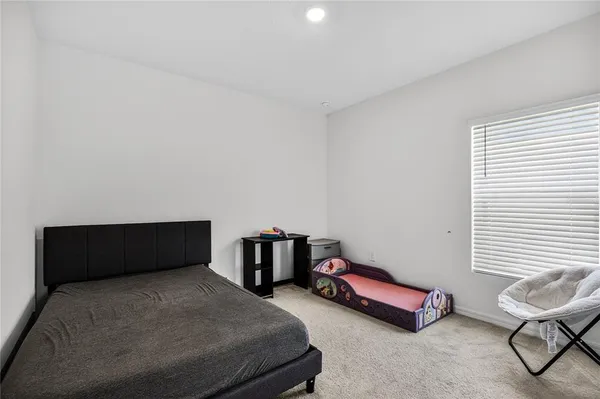 a bedroom with furniture and a window
