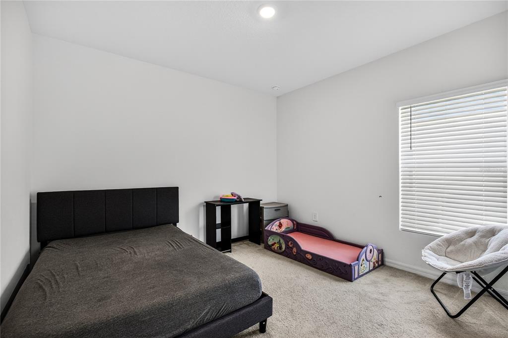 9633 Rampart Road Leesburg, FL 34788 - Photo 22 of 34 a bedroom with furniture and a window