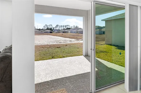 a view of a floor to ceiling window and a yard