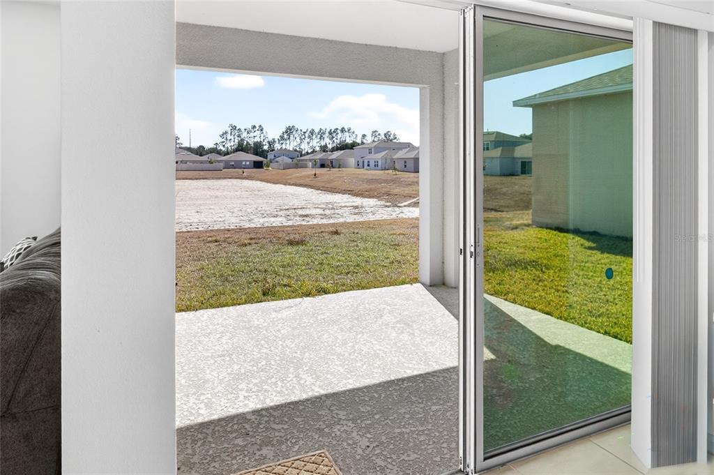 9633 Rampart Road Leesburg, FL 34788 - Photo 25 of 34 a view of a floor to ceiling window and a yard