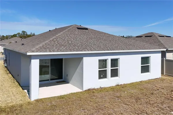 a view of a house with a backyard