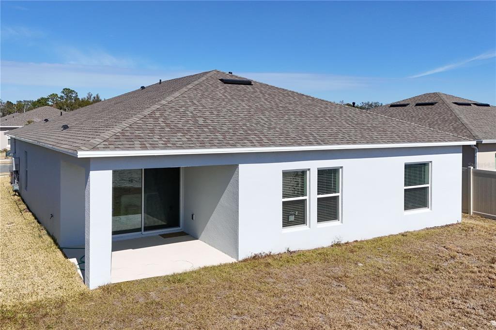 9633 Rampart Road Leesburg, FL 34788 - Photo 27 of 34 a view of a house with a backyard