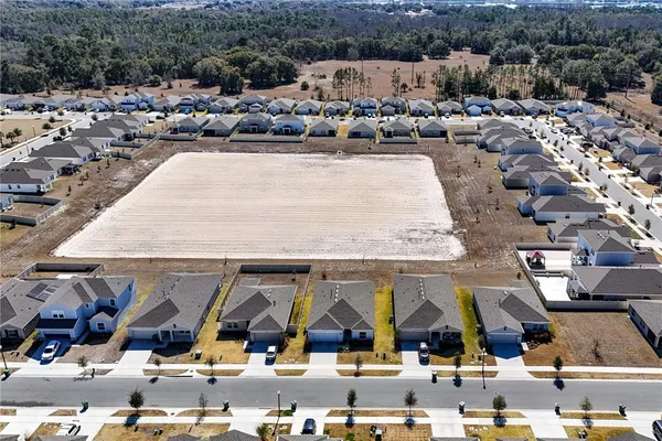 an aerial view of houses with outdoor space