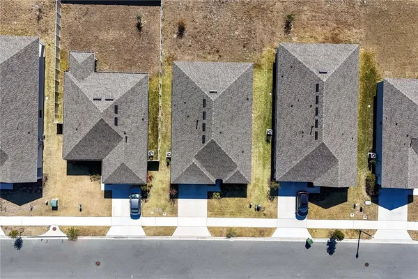 an aerial view of residential houses with city view