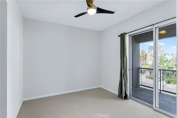 an empty room with windows and entrance