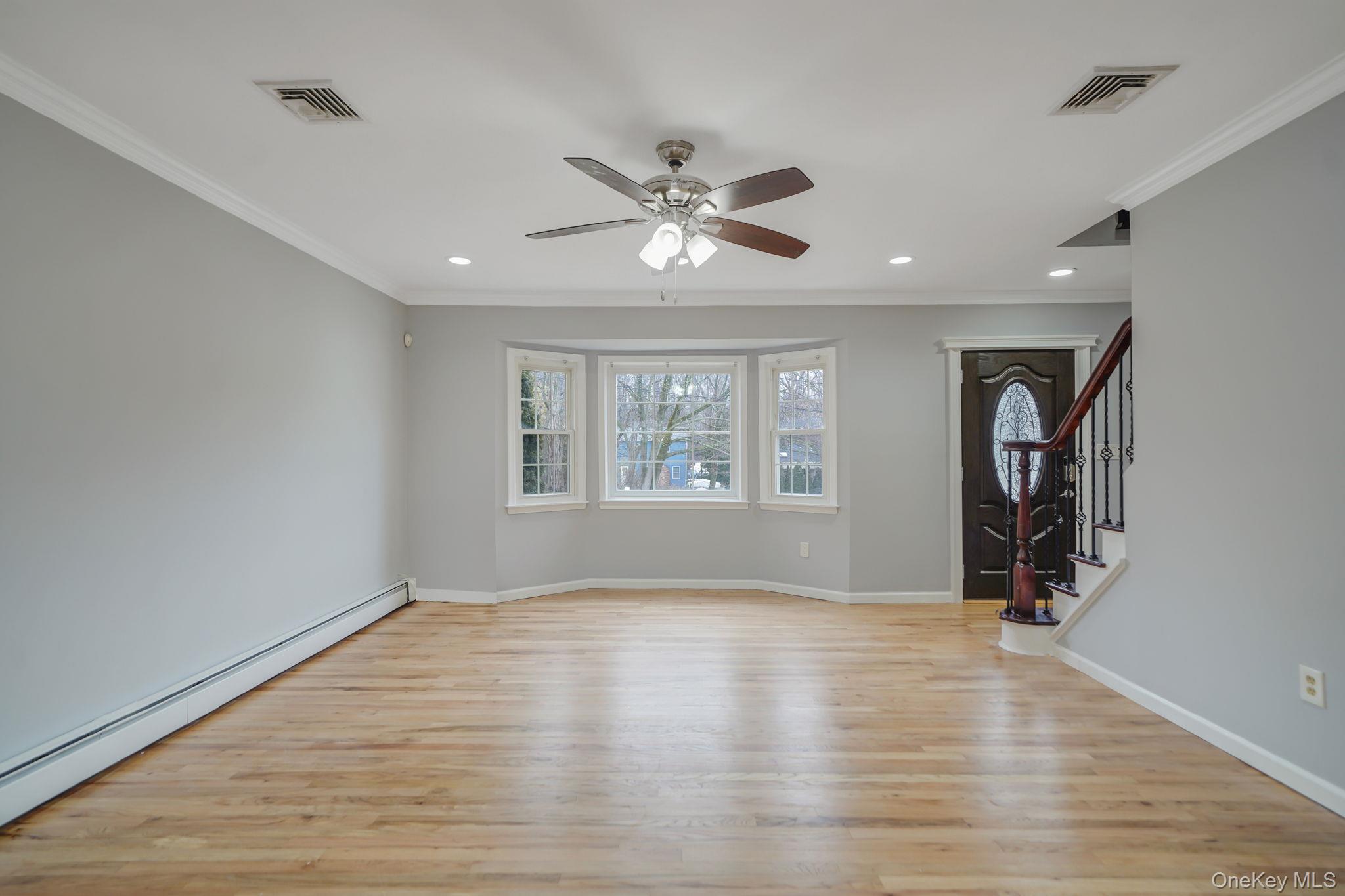92 Hawthorne Road Kings Park, NY 11754 - Photo 11 of 33 wooden floor in an empty room with a window