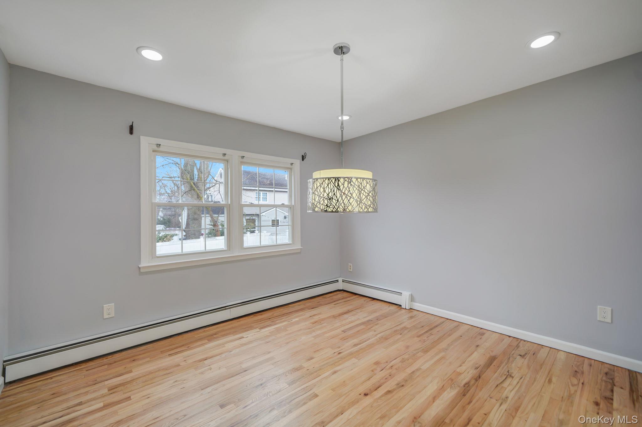 92 Hawthorne Road Kings Park, NY 11754 - Photo 13 of 33 a view of an empty room with wooden floor and a window