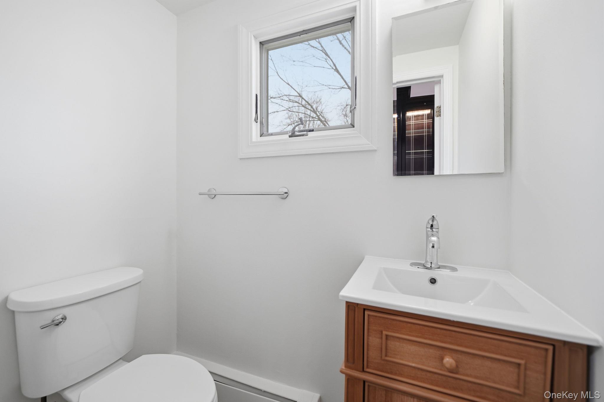 92 Hawthorne Road Kings Park, NY 11754 - Photo 16 of 33 a bathroom with a toilet and a sink