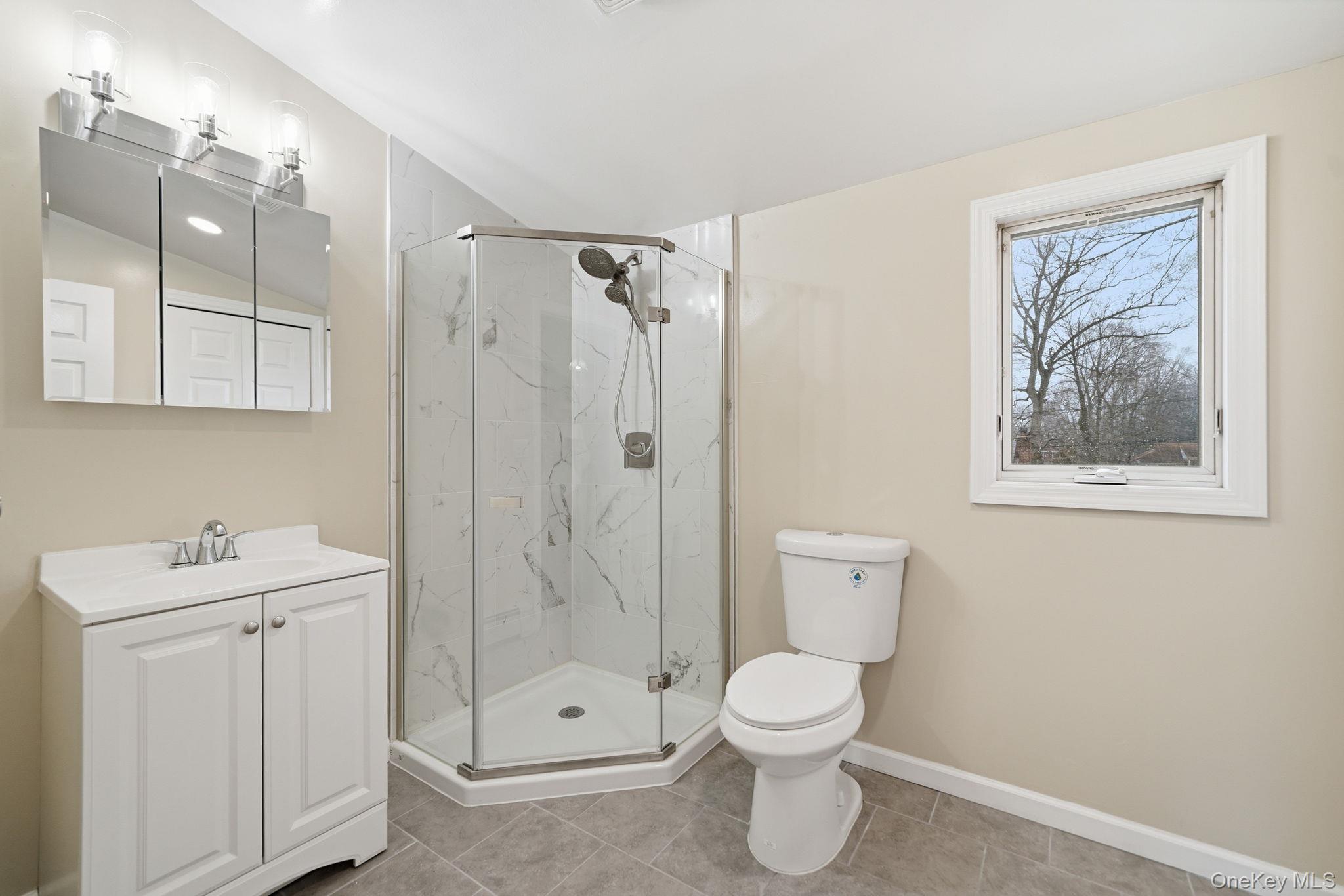 92 Hawthorne Road Kings Park, NY 11754 - Photo 17 of 33 a bathroom with a toilet sink and shower