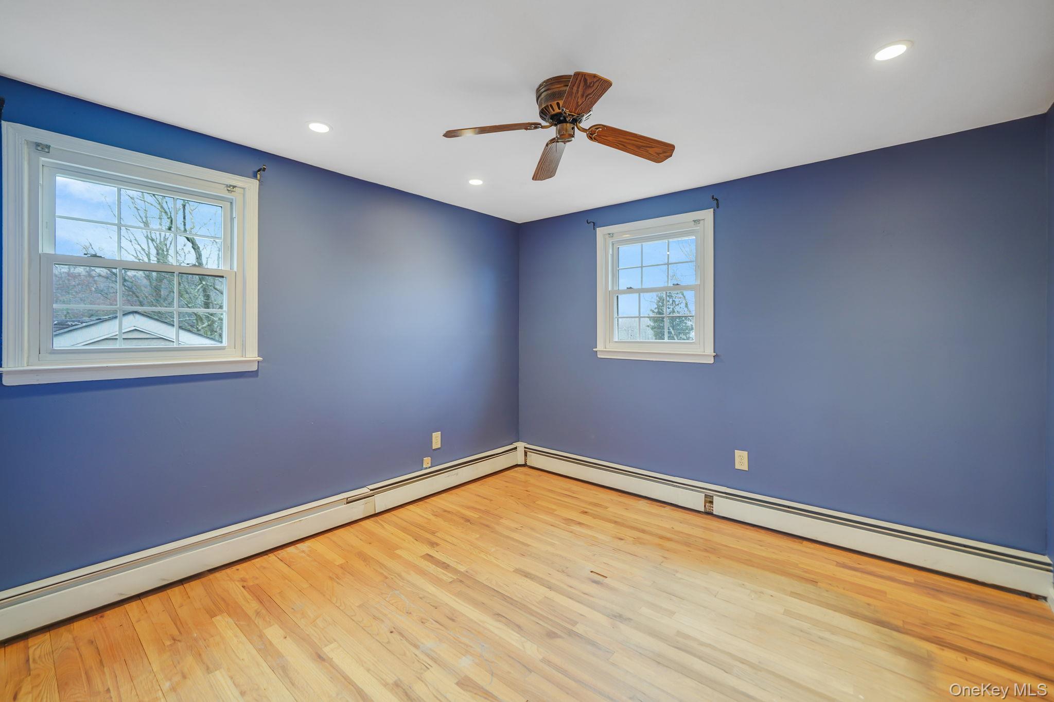 92 Hawthorne Road Kings Park, NY 11754 - Photo 20 of 33 a view of empty room with windows