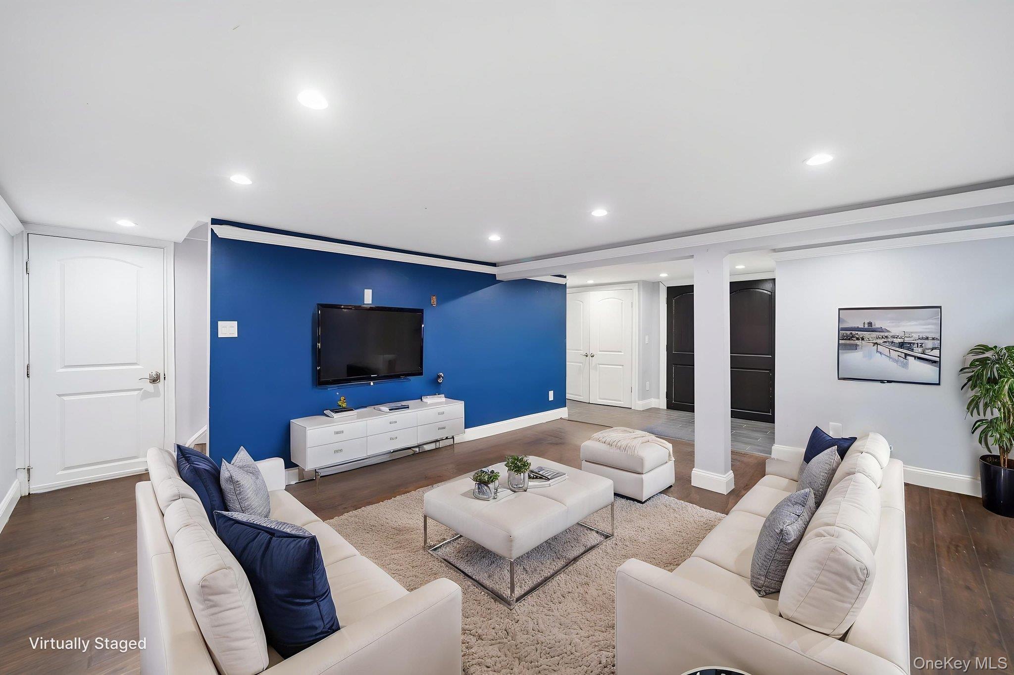 92 Hawthorne Road Kings Park, NY 11754 - Photo 23 of 33 a living room with furniture and a flat screen tv