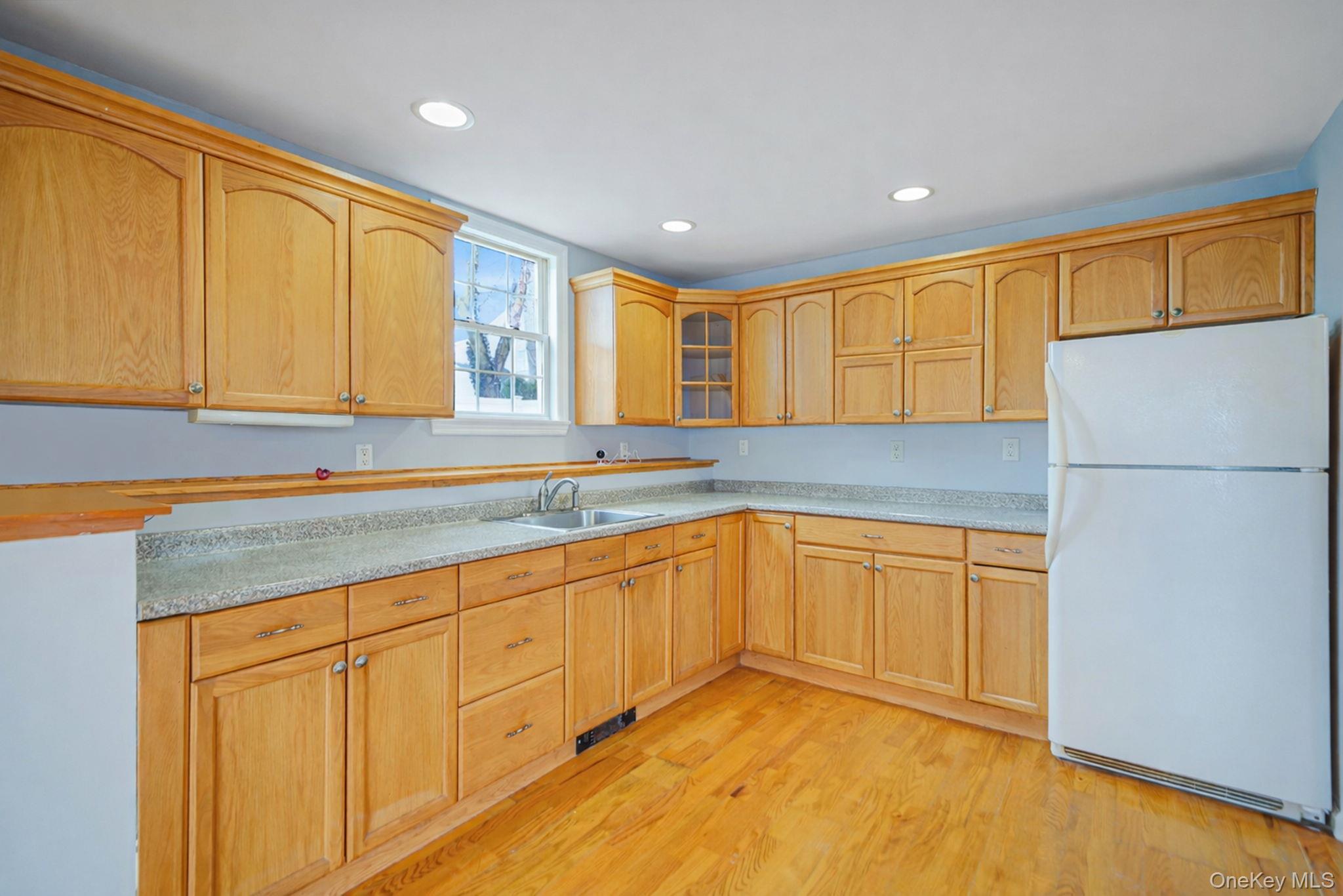 92 Hawthorne Road Kings Park, NY 11754 - Photo 24 of 33 a kitchen with granite countertop cabinets stainless steel appliances a sink and a window