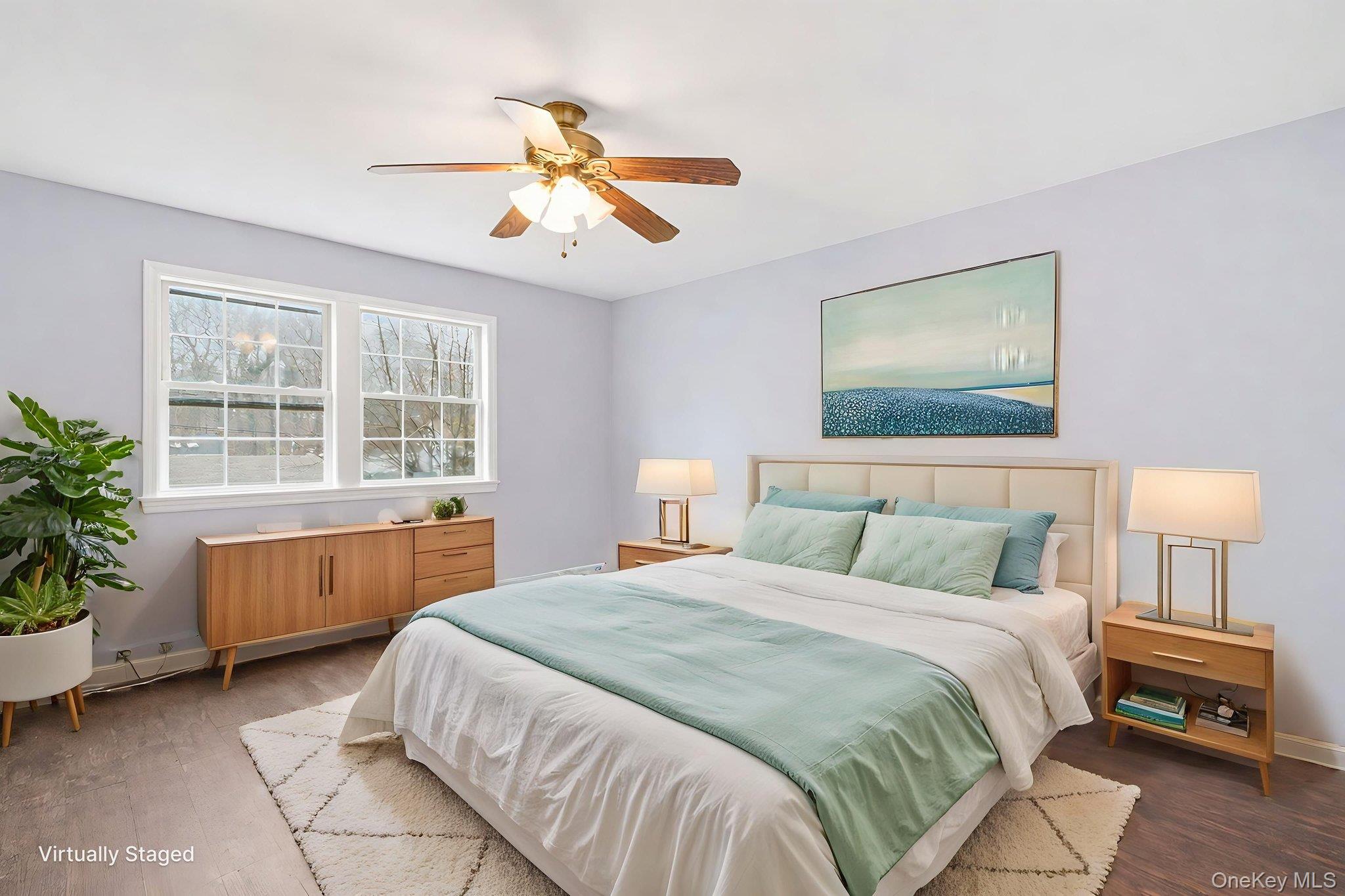 92 Hawthorne Road Kings Park, NY 11754 - Photo 28 of 33 a bedroom with a large bed and a chandelier