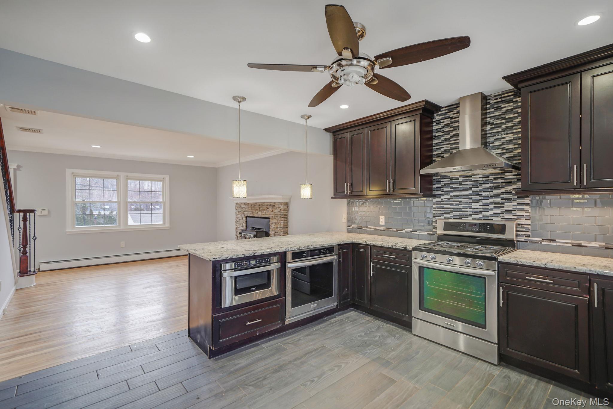92 Hawthorne Road Kings Park, NY 11754 - Photo 5 of 33 a kitchen with stainless steel appliances granite countertop a stove and a sink
