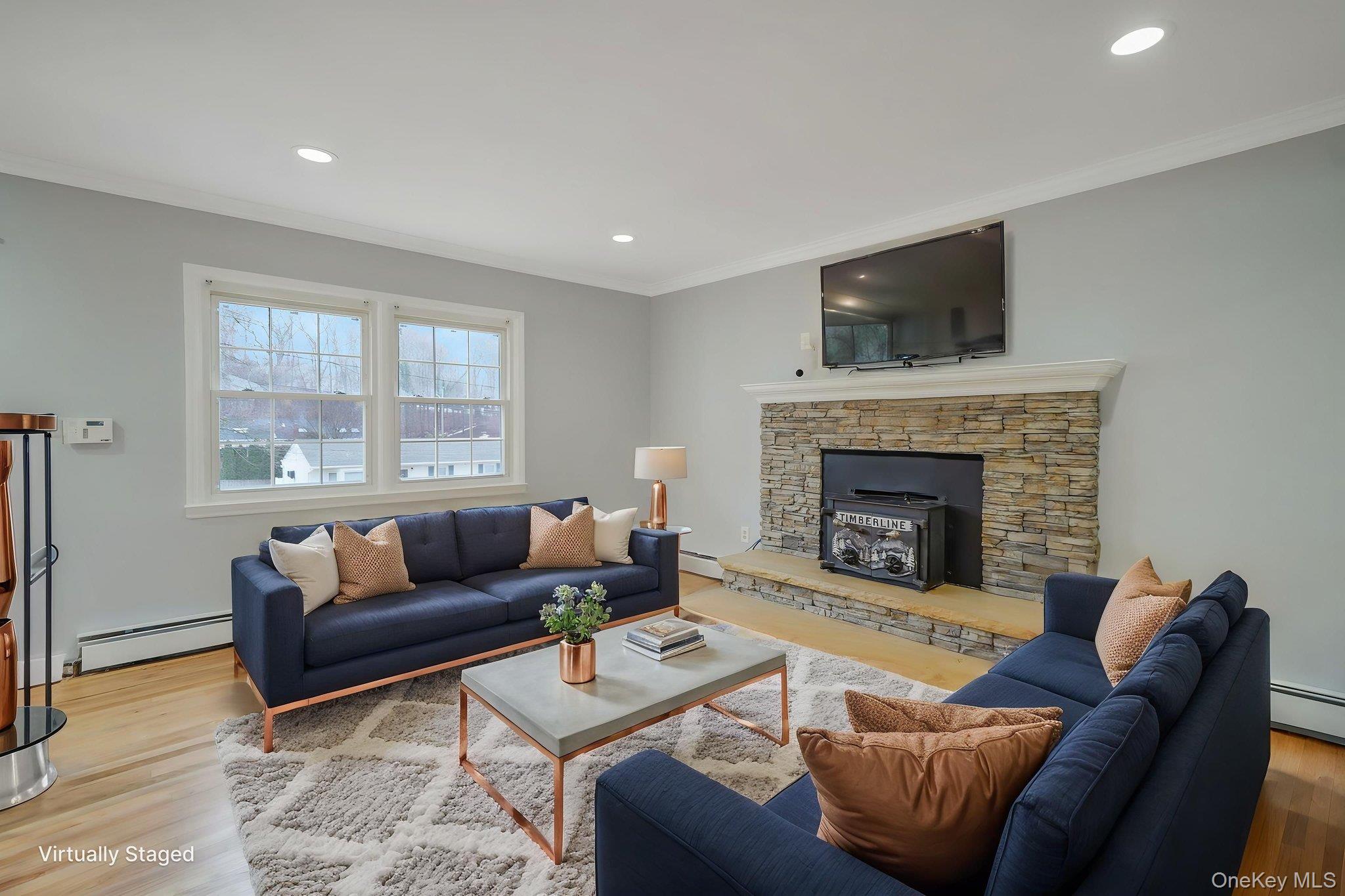 92 Hawthorne Road Kings Park, NY 11754 - Photo 8 of 33 a living room with furniture a flat screen tv and a fireplace