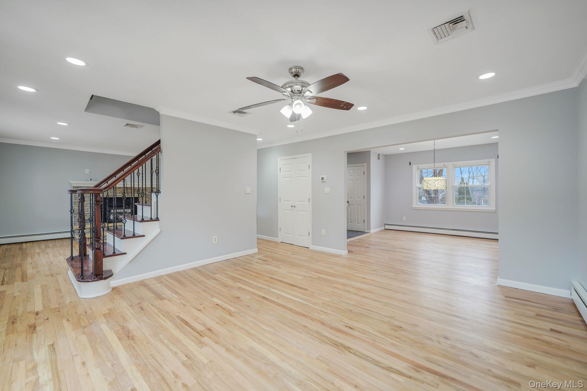 92 Hawthorne Road Kings Park, NY 11754 - Photo 9 of 33 a view of an empty room with window and wooden floor