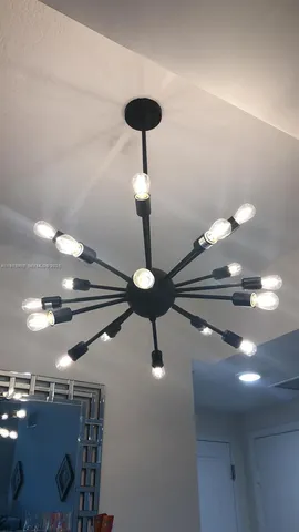 a view of a dining room with furniture and chandelier