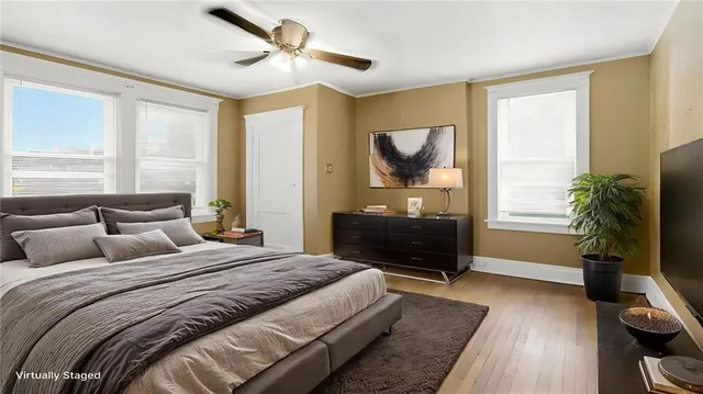 a bedroom with a bed flat screen tv and a window