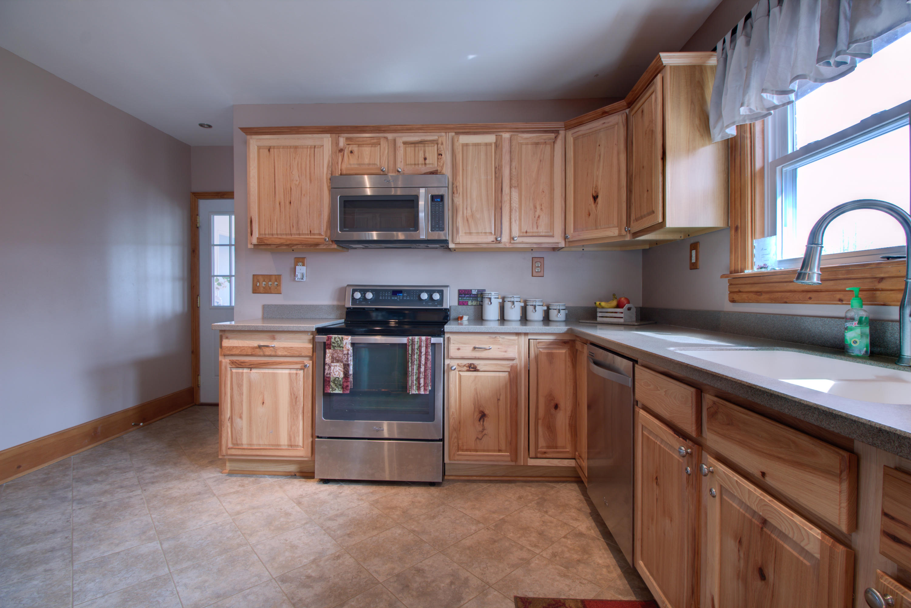 4324 Rakes Road Roanoke, VA 24014 - Photo 3 of 38 a kitchen with stove a microwave and cabinets
