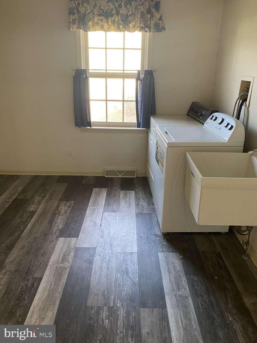 1837 Downing Street York, PA 17408 - Photo 11 of 21 wooden floor in an empty room with a window
