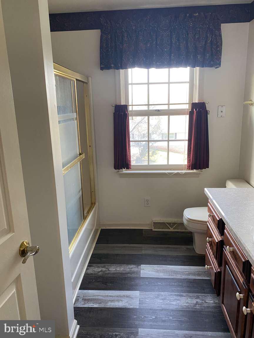 1837 Downing Street York, PA 17408 - Photo 16 of 21 a bathroom with a sink a toilet a window and vanity