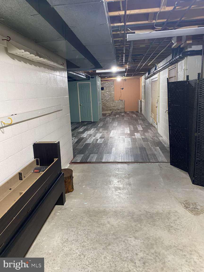 1837 Downing Street York, PA 17408 - Photo 19 of 21 a view of an empty room with wooden floor and a kitchen