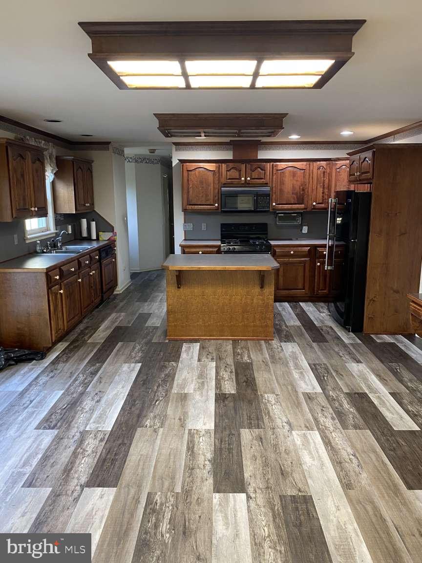 1837 Downing Street York, PA 17408 - Photo 3 of 21 a large kitchen with stainless steel appliances kitchen island granite countertop a refrigerator and a stove top oven
