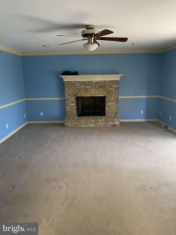 a view of empty room with a fireplace