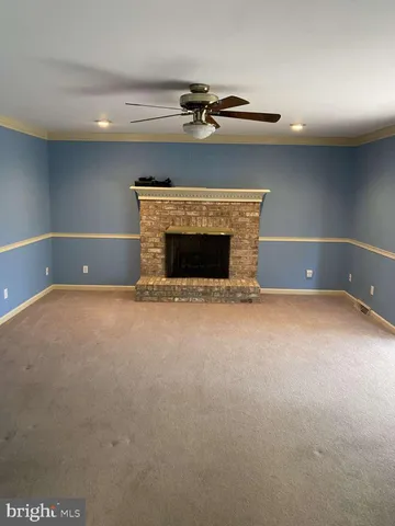 a view of empty room with a fireplace