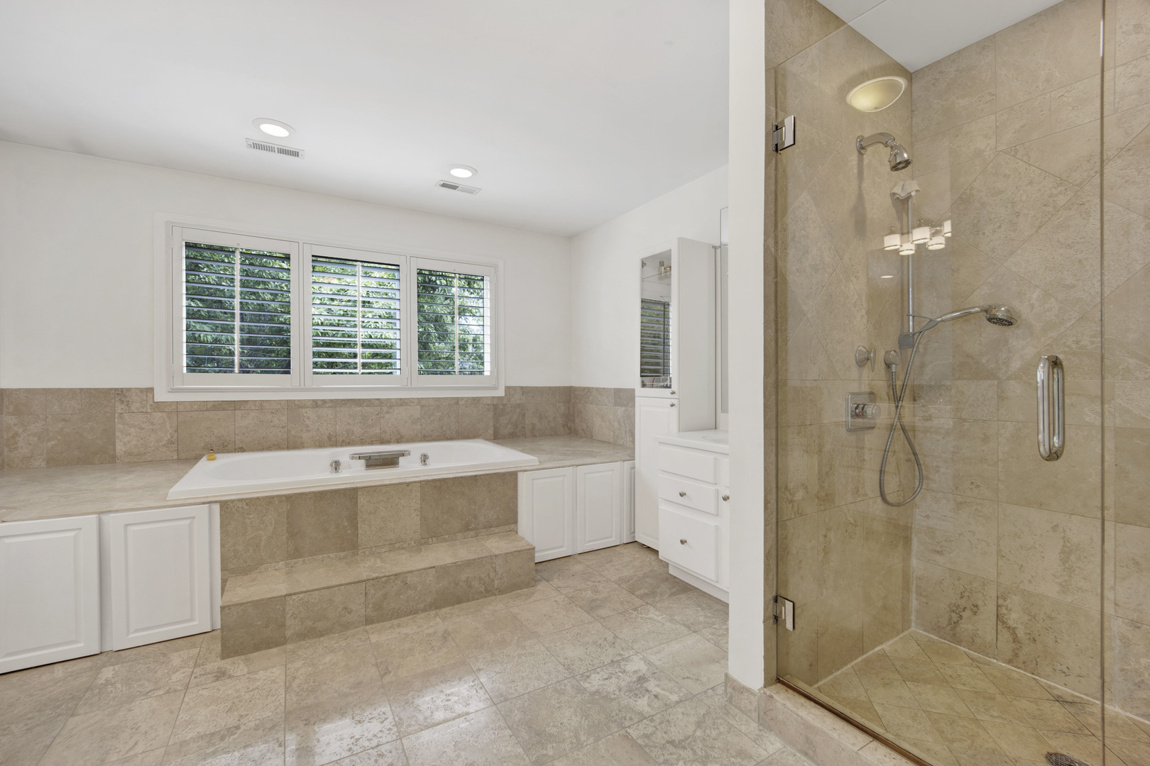 2310 Illinois Road Northbrook, IL 60062 - Photo 19 of 41 a bathroom with a tub sink shower and mirror