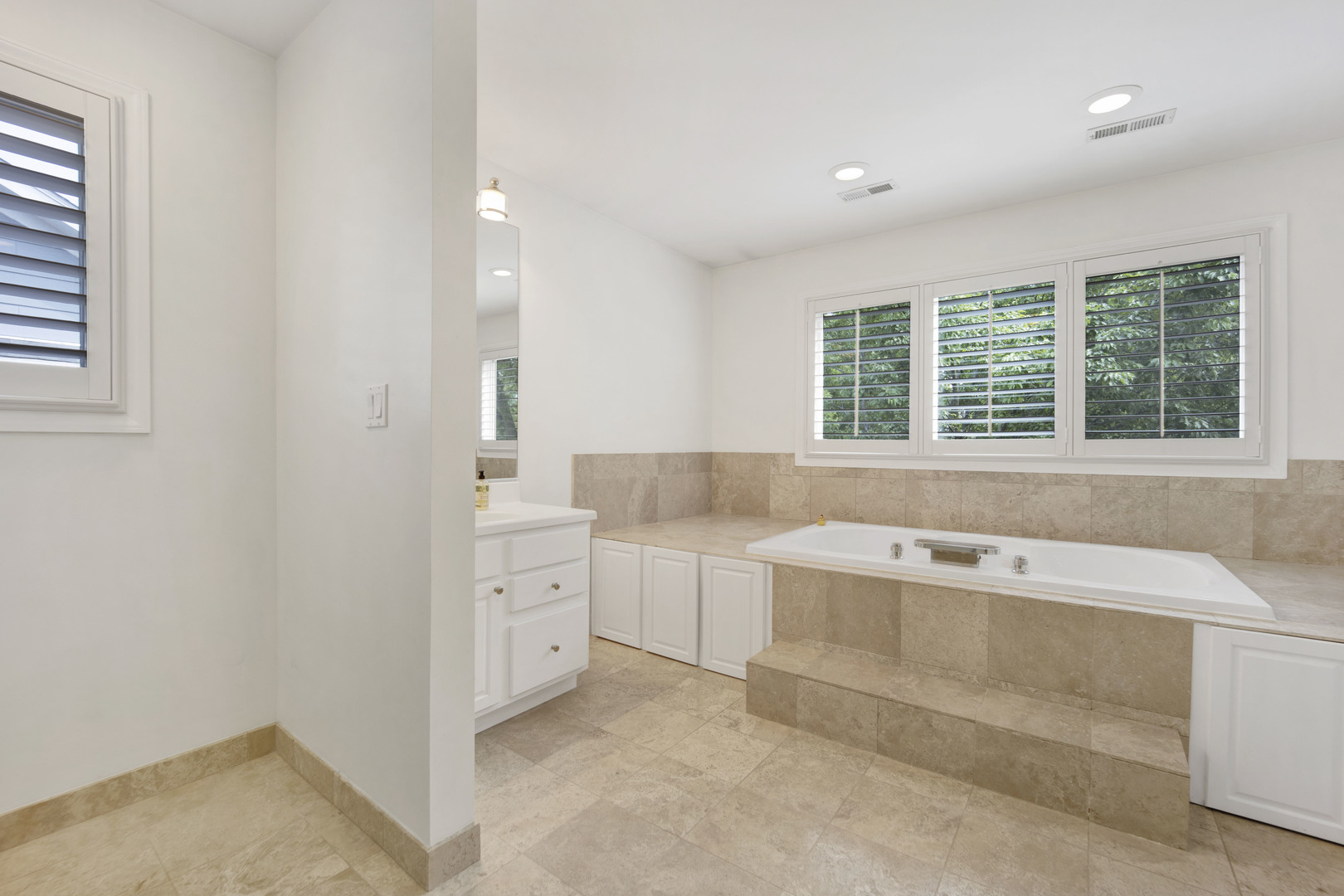 2310 Illinois Road Northbrook, IL 60062 - Photo 21 of 41 a spacious bathroom with a tub sink and mirror