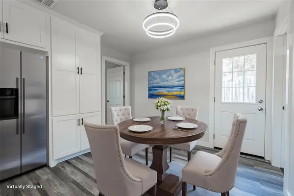 a view of a dining room with furniture and wooden floor