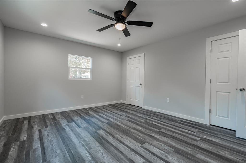 304 Pine Street Seven Points, TX 75143 - Photo 21 of 38 wooden floor in an empty room with a window