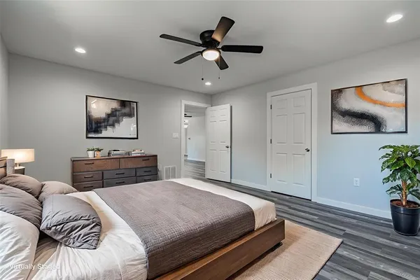 a bedroom with a large bed and a chandelier