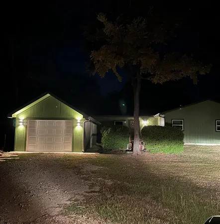 a view of a house with backyard and tree