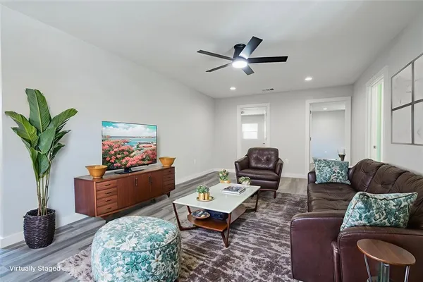 a living room with furniture and a potted plant