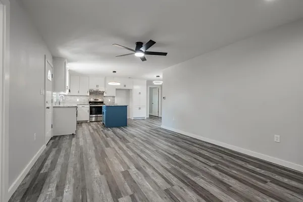 a view of kitchen with wooden floor and window