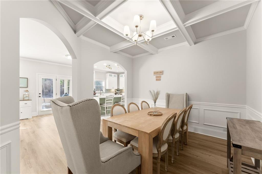 6667 Rivergreen Road Flowery Branch, GA 30542 - Photo 12 of 50 a view of a dining room with furniture wooden floor and chandelier